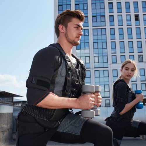 athlets wearing ems vests and trying to loss their weight athlets wearing ems vests and trying to loss their weight outdoors. physiotherapy concept